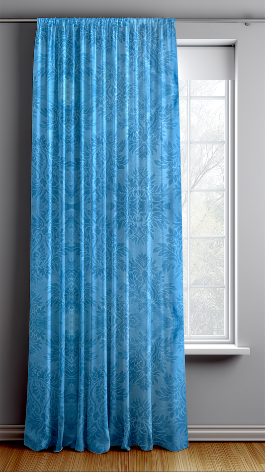 Blue curtain hanging in front of a window with a gray wall background