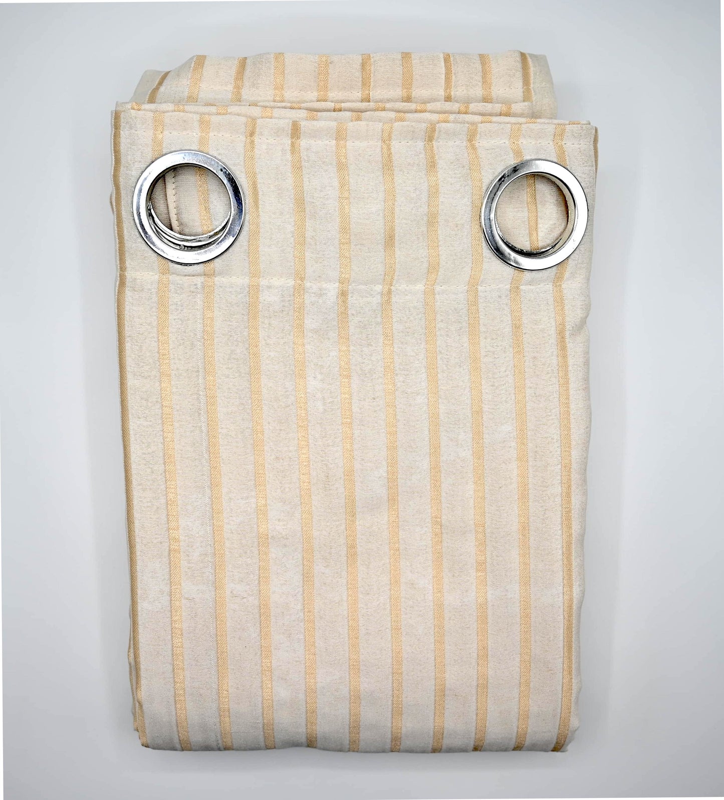 Striped curtain with metallic rings on a light gray background