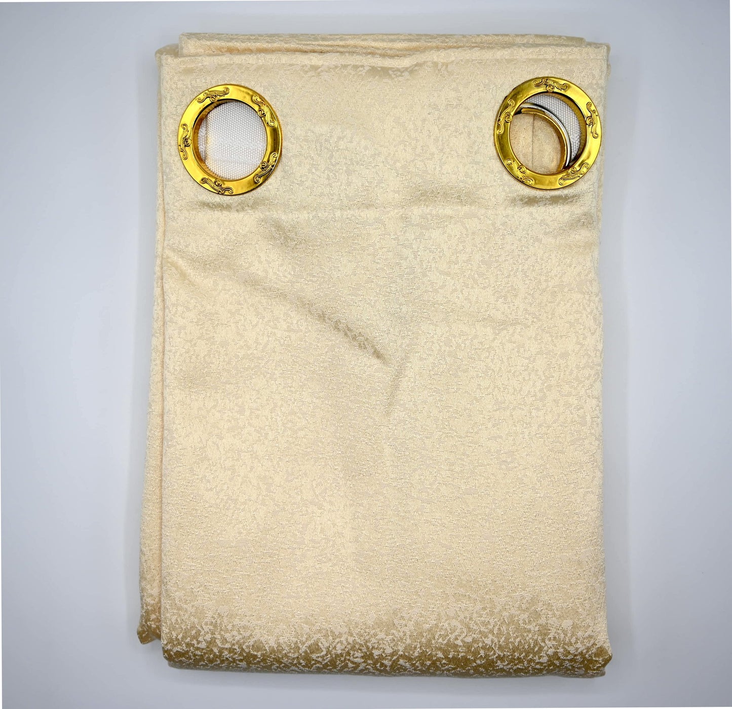 Beige fabric with gold circular patterns on a gray background