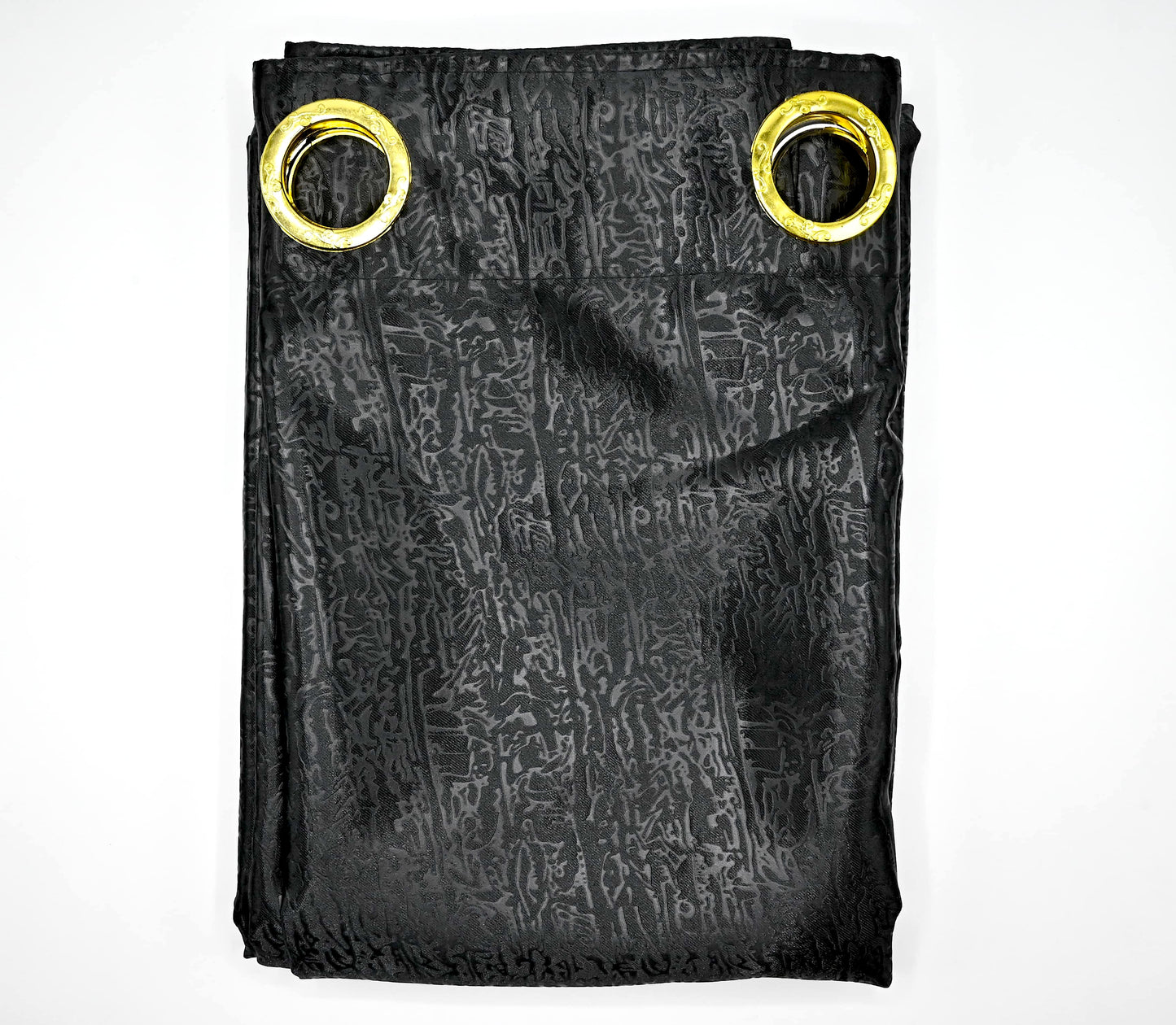 Black patterned fabric with gold grommets on a white background