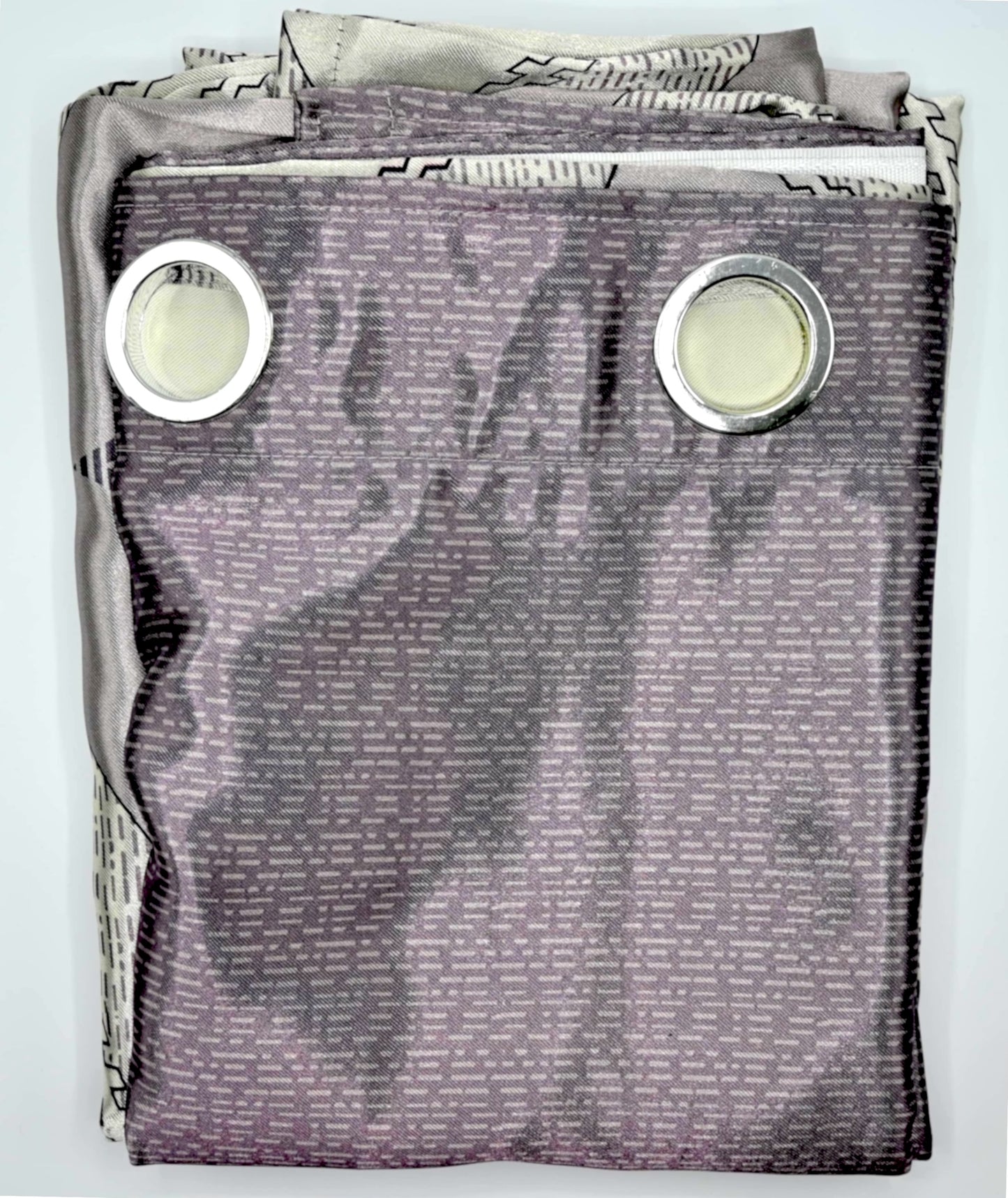 Folded fabric with grommets on a light gray background