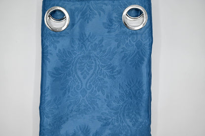 Blue curtain with floral pattern and metallic eyelets on a white background