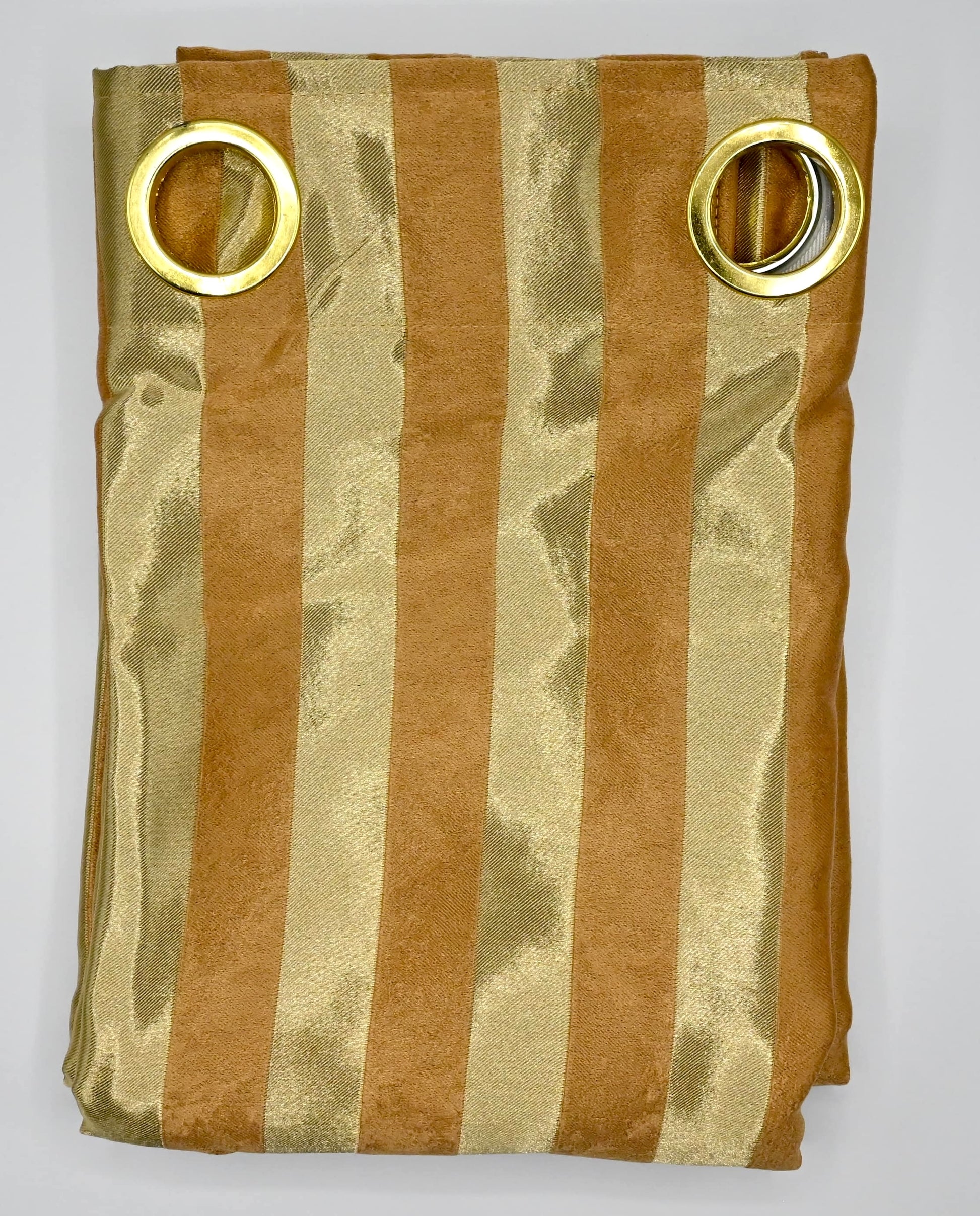 Folded fabric with gold and bronze stripes and gold rings on a white background