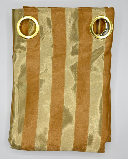 Folded fabric with gold and bronze stripes and gold rings on a white background