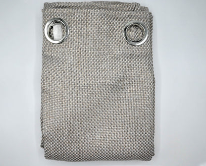 Folded textured fabric with metal rings on a light gray background