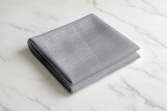 Folded grey textured fabric curtain panel, premium polyester blend, soft sheen finish Grey Haven collection
