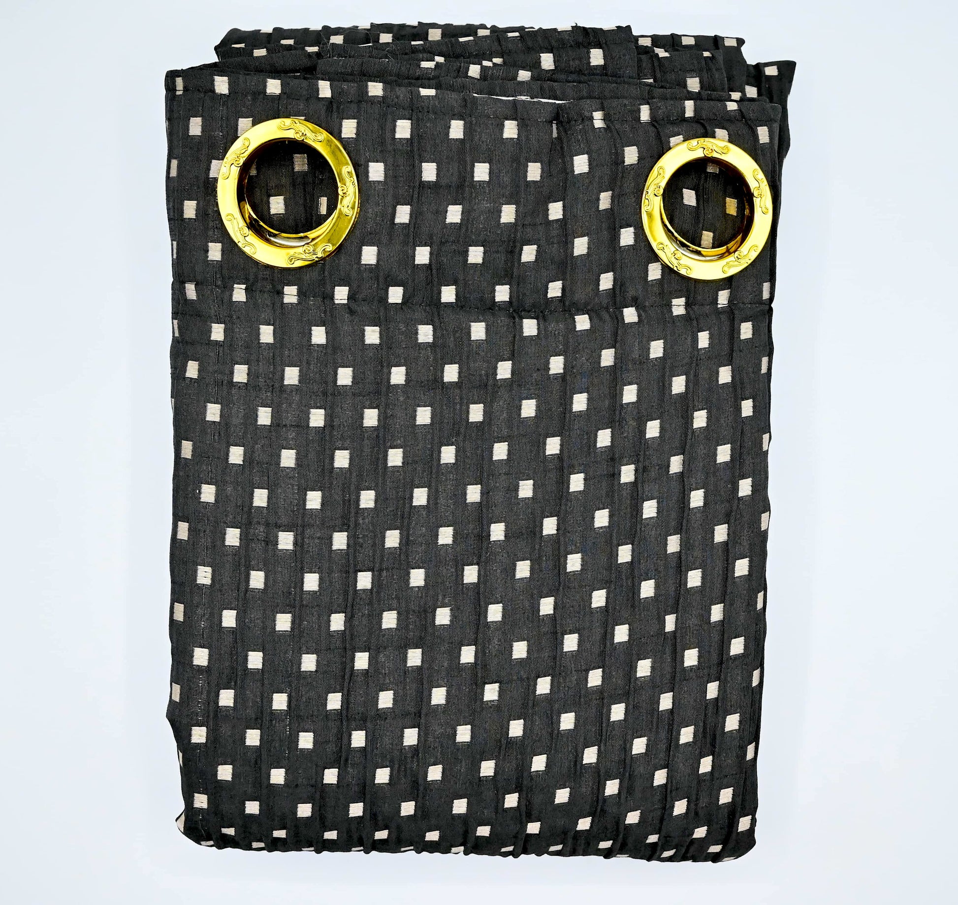 Black and white checkered curtain with gold eyelets on a light blue background