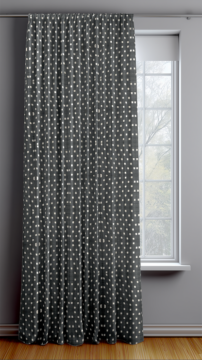 Black ready made curtain with white polka square in a room with a window
