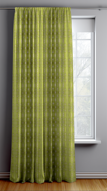 Green curtain hanging in front of a window with a gray wall background