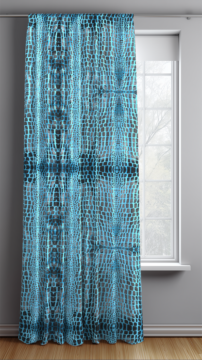 Blue patterned curtain in front of a window with a gray wall background