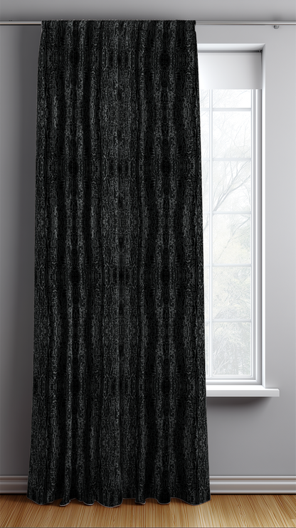 Black textured curtain in front of a window with a light gray wall.