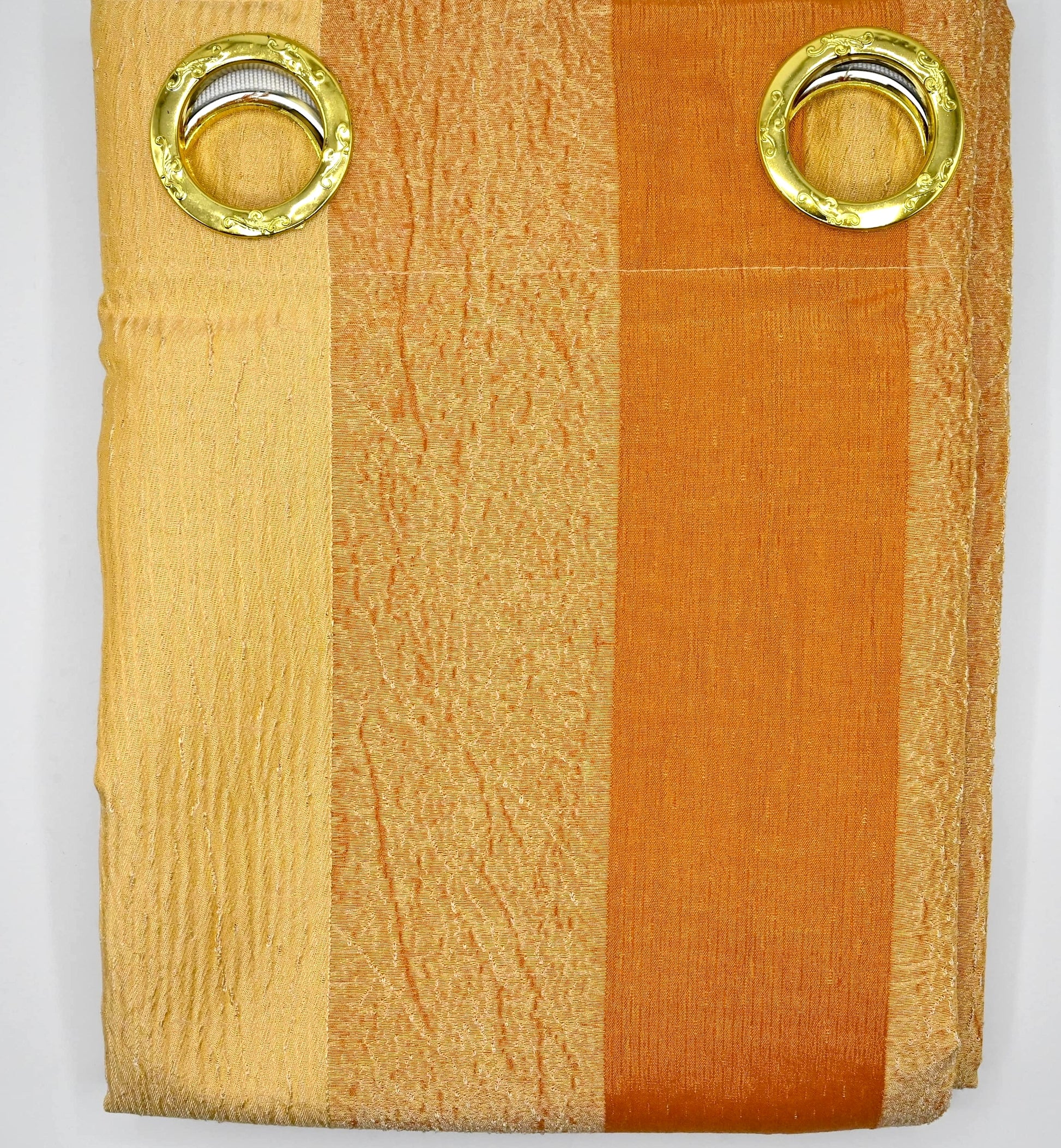 Folded fabric with gold eyelets on a white background