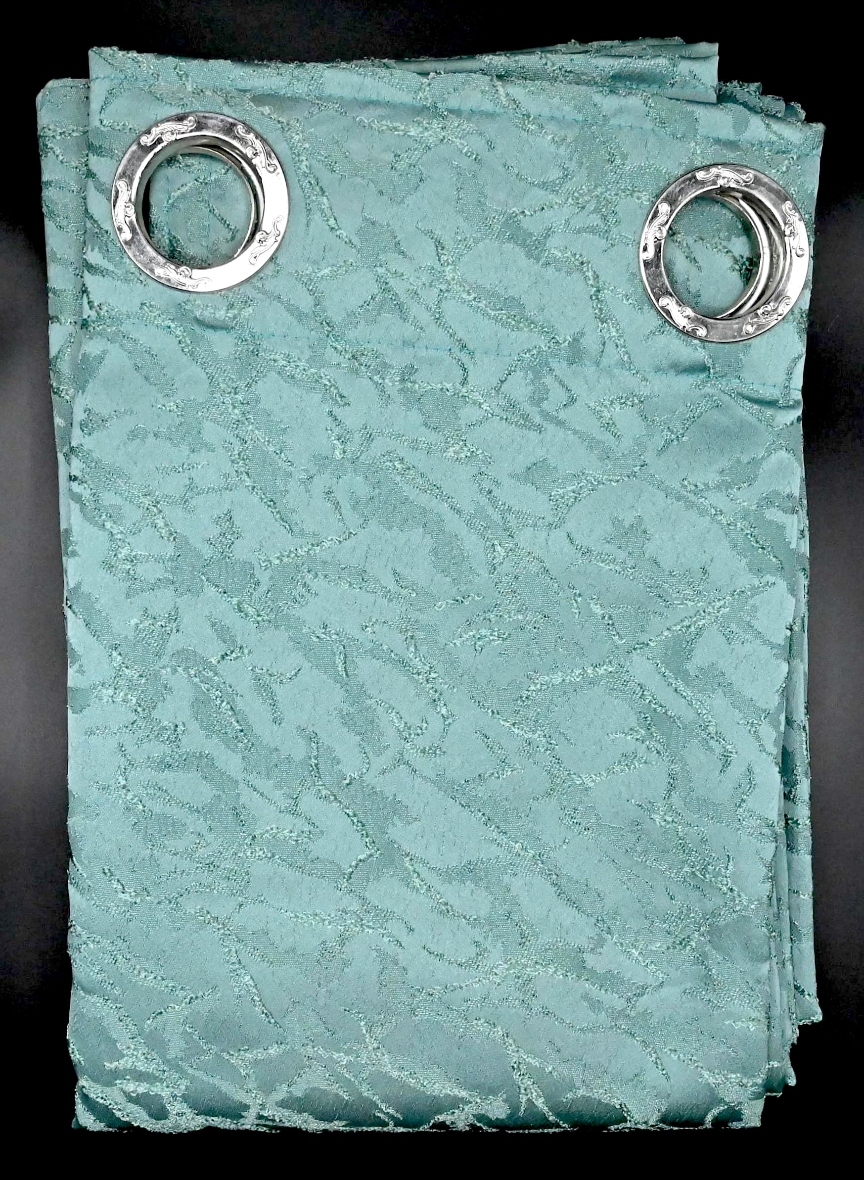 Seafoam vine coloured curtain with silver grommets on a black background